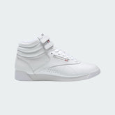 Reebok Freestyle Hi Women's sneakers in white with a high top design, lace closure, and ankle strap.