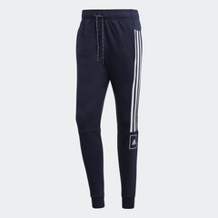 Navy blue Adidas jogger pants with white stripes on a light gray background