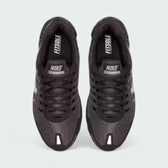 Top-down view of a pair of Nike Air Max Torch Men's running trainers in black, highlighting their streamlined silhouette and lace-up closure.
