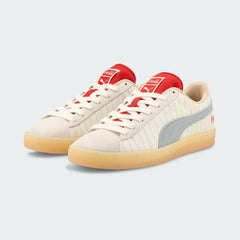 Angled view of two Puma Suede x Coca-Cola Unisex trainers in white, beige, and red, side by side, showcasing their iconic collaboration design.