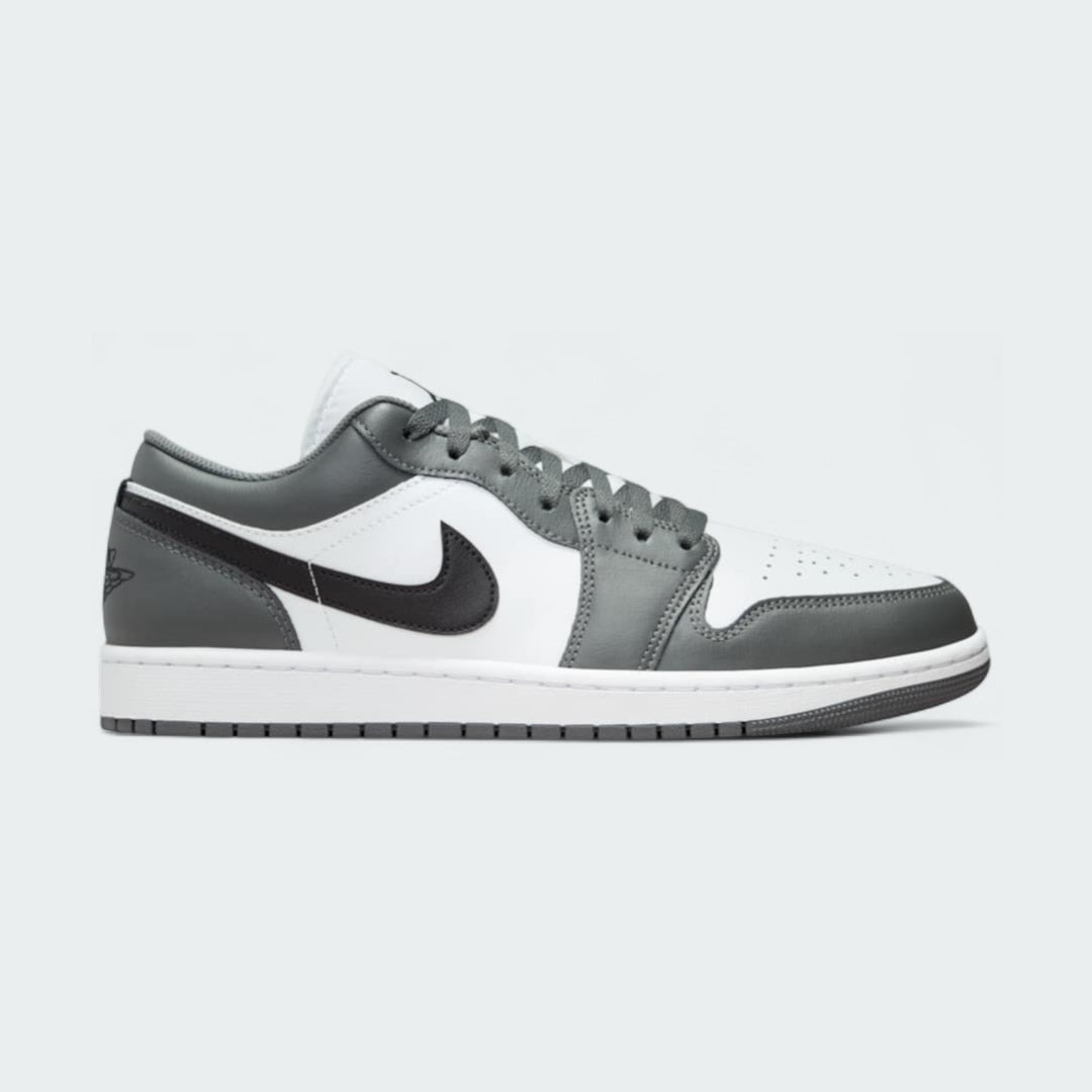 Air Jordan 1 Low Men's trainers in white, black, and grey, side profile showing leather upper, low-top design, and black Nike Swoosh.