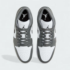 Top-down view of a pair of Air Jordan 1 Low Men's trainers in white, black, and grey, highlighting their classic silhouette and lace-up closure.
