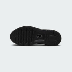 View of the outsole of the Nike Air Max 2013 Juniors' black trainers, showing the durable rubber tread pattern with flex grooves.