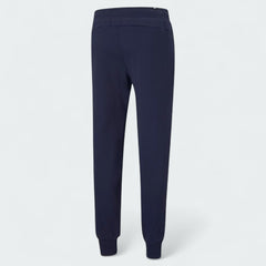 Puma Essential Logo Pants Men's in navy fleece, back view showcasing the tapered leg design and ribbed cuffs.
