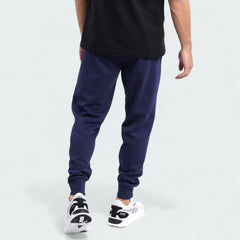 Puma Essential Logo Pants Men's in navy fleece, back view worn by a model showcasing the tapered leg design and ribbed cuffs.