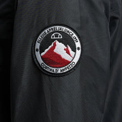 Close-up zoom on the fabric of the Ellesse Mont 2 Overhead Jacket, showing the textured marl finish and the embroidered or printed Ellesse logo.