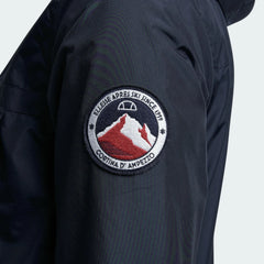 Close-up zoom on the fabric of the Ellesse Mont 2 Overhead Anorak Jacket, showing the textured finish and the embroidered or printed Ellesse logo.