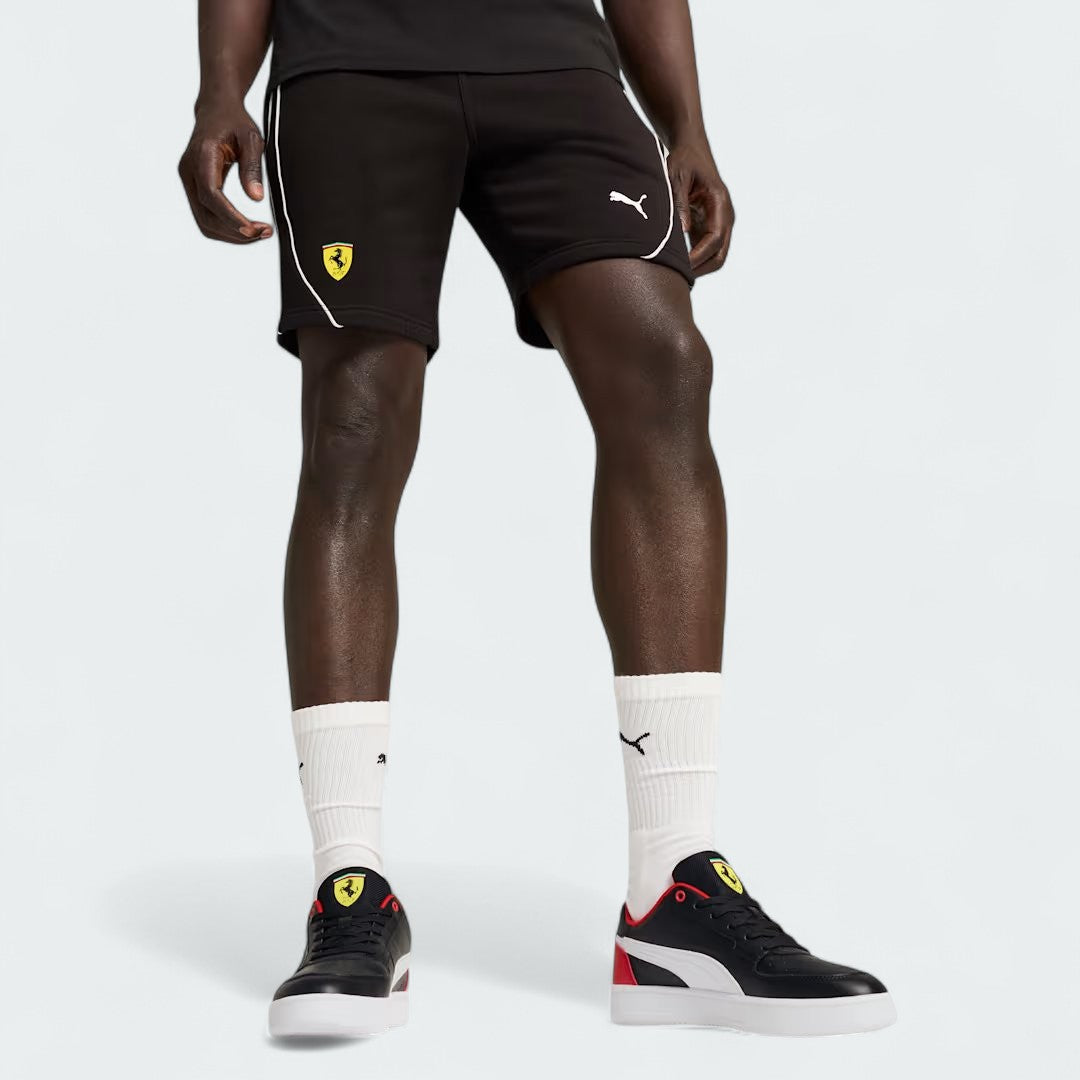 Puma x Ferrari Race Shorts Men's in black model worn, front view showing the elastic waistband, drawcord, and embroidered Ferrari and Puma logos.