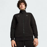 Puma x Ferrari Style MT7 Jacket Men's in black, worn by a model front view showing full-zip closure, stand-up collar, and embroidered Ferrari and Puma logos.
