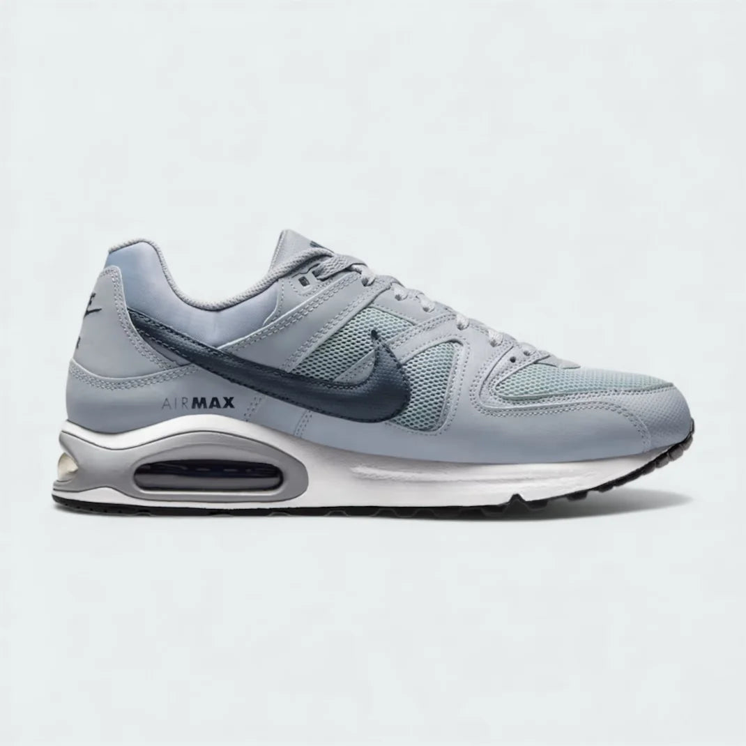 Nike Air Max Command Men's trainers in grey with blue and black accents, side profile showing mesh and synthetic upper, visible Max Air unit in heel, and classic Swoosh.
