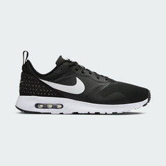 Nike Air Max Tavas Men's trainers in black, side profile showing mesh upper, visible Max Air unit in the heel, and sleek silhouette.