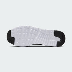 View of the outsole of the Nike Air Max Tavas Men's black trainers, showing the durable rubber waffle tread pattern.