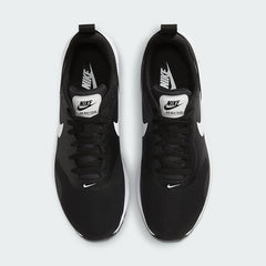 Top-down view of a pair of Nike Air Max Tavas Men's trainers in black, highlighting their streamlined design and lace-up closure.