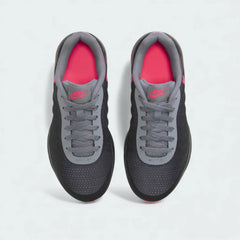 Top-Down view of a pair of Nike Air Max Invigor Children's trainers in black, pink, and grey, highlighting their sleek silhouette and lace-up closure.