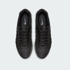 Top-down view of a pair of Nike Air Max Invigor Men's trainers in black, highlighting their streamlined design and lace-up closure.