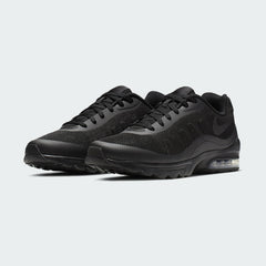 Angled view of two Nike Air Max Invigor Men's black trainers, side by side, showcasing their modern aesthetic and lightweight construction.