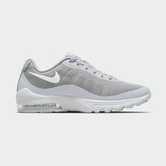 Nike Air Max Invigor Men's trainers in wolf grey with white accents, side profile showing mesh upper, prominent visible Max Air unit in the heel, and sleek silhouette.