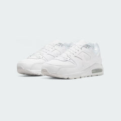 Angled view of two Nike Air Max Command Men's white leather trainers, side by side, showcasing their classic aesthetic and cushioned design.