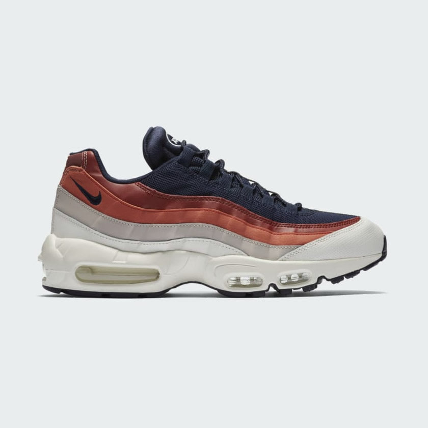 Nike Air Max 95 Essential Men's sneaker in colors Sail/Obsidian/Desert Sand, showcasing the side profile of the shoe with visible mesh upper, leather and synthetic leather reinforcements, and the unique lacing system.