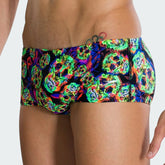 Speedo Men's 14cm swimming brief with skulls print worn by a male swimmer, showcasing its fit and freedom of movement in the water.
