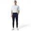 Person wearing navy jogger pants with a red logo and a white t-shirt on a white background