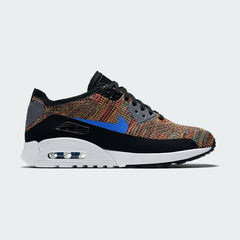 Nike Air Max 90 Ultra 2.0 Flyknit Women's trainers in black and white, side profile showing Flyknit upper, visible Max Air unit, and cored-out Ultra 2.0 midsole.