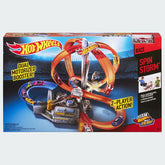 Hot Wheels Spin Storm playset box, showing the track with spinning obstacles, a motorized booster, and a Hot Wheels car racing on it.