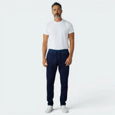 Highlights the tapered leg silhouette and the professional finish of the tonal navy 3-Stripes.