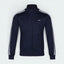 Highlights the high-velocity sweep of the continuous crisp White 3-Stripes tracking cleanly down the Navy blue arm, showing the professional, texturized weave of the heavyweight piqué fabric blend.