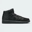Highlights the high-velocity sweep of the classic leather Jordan Swoosh, showing the professional panel stitching of the real black leather overlays, the crisp stamped debossing of the Air Jordan Wings logo on the ankle collar panel, and the solid matte black finish of the rubber midsole wall.