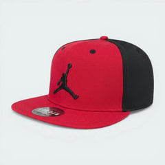 Red and black cap with a logo on a light gray background