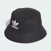 The Black Trefoil Bucket Hat, highlighting the downward-sloping brim and the reinforced stitching around the crown.