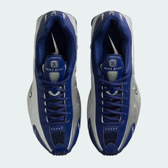Top-down view of a pair of Nike Shox R4 women's trainers in blue, highlighting their classic silhouette and lace-up closure.