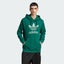Model profile of the Collegiate Green Adidas hoodie, showcasing the relaxed regular fit and the structured ribbed cuffs.