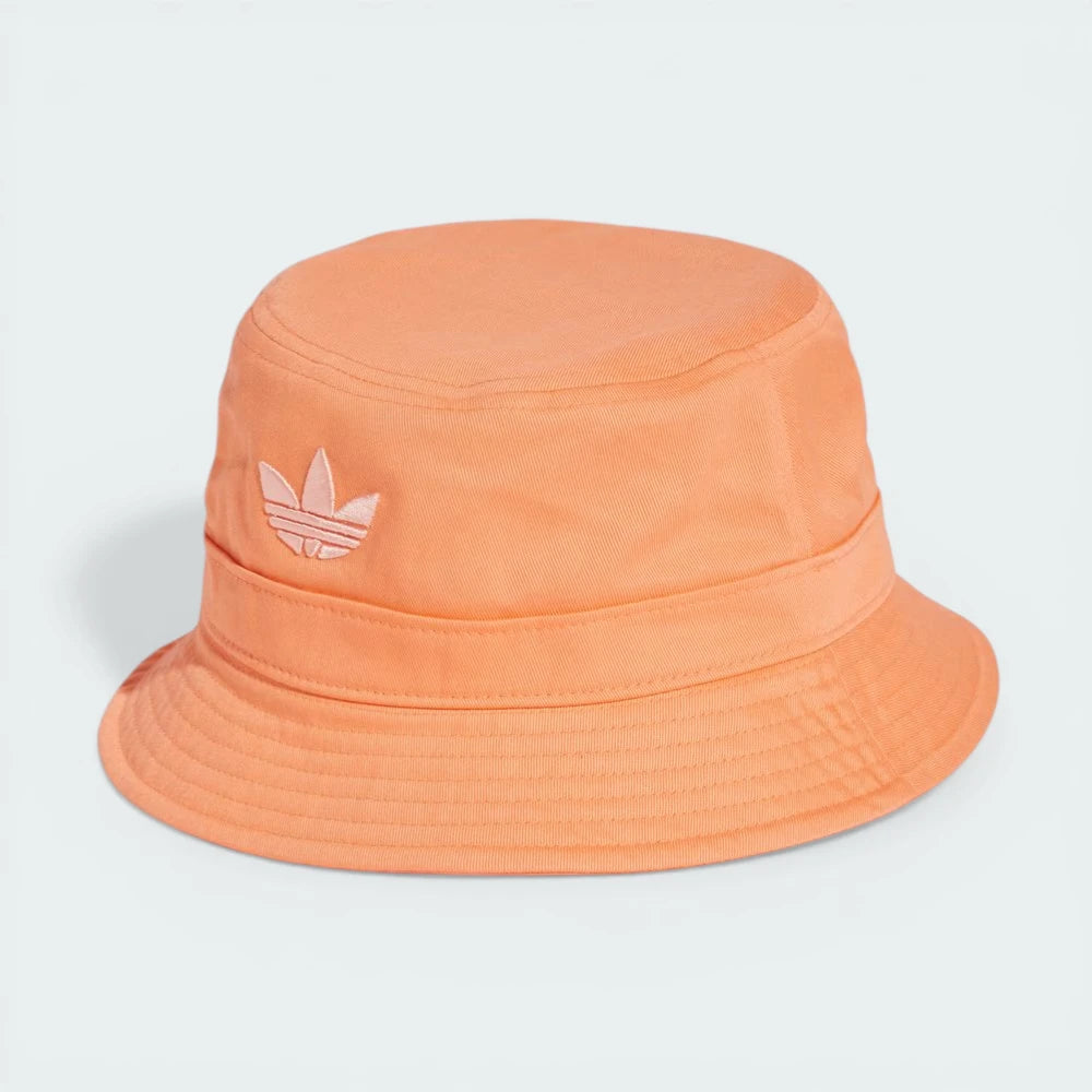 Side profile of the Semi Coral Adidas bucket hat, highlighting the downward-sloping pre-curved brim.