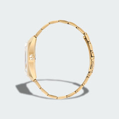 Adidas Edition One Watch in gold metallic, side profile showing the thickness of the case and the links of the stainless steel bracelet.