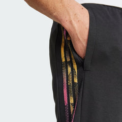Close-up zoom on the fabric of the Adidas Tiro Running Track Pants in black, showing the colourful stripes
