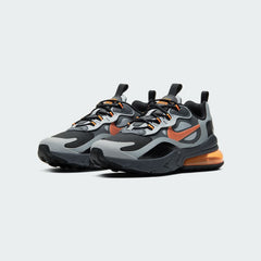 Angled view of two Nike Air Max 270 React Winter Juniors' trainers in black with orange and grey, side by side, showcasing their bold design and visible Air unit.