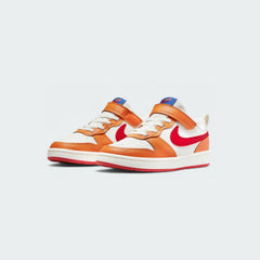 Angled view of two Nike Court Borough Low 2 children's trainers in sail with colorful accents, side by side, showcasing their classic aesthetic.