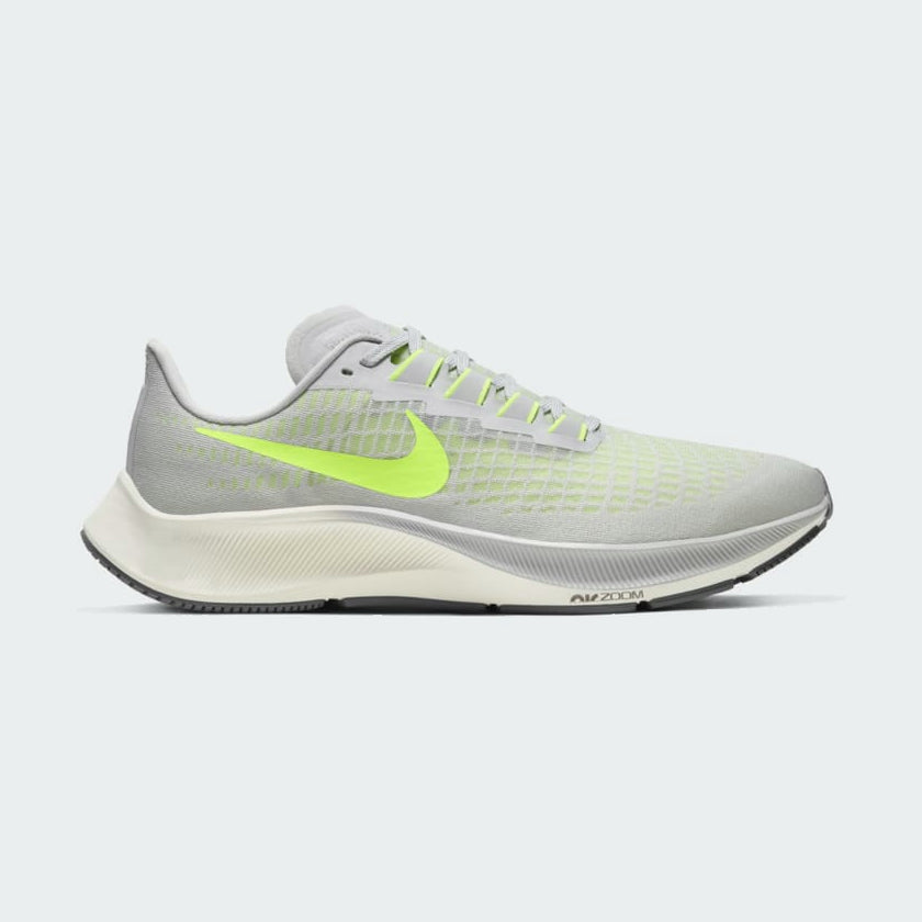 Nike Air Zoom Pegasus 37 Men's running trainers in grey fog with vibrant volt accents, side profile showing engineered mesh upper, Nike Swoosh, and cushioned midsole.