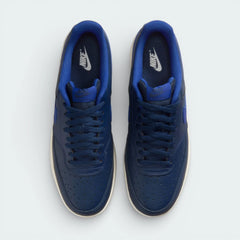 Top-down view of the navy trainers, highlighting the perforated toe box and the matching navy lacing system.
