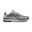 Highlights the high-velocity sweep of the black-outlined metallic silver Nike Swoosh, showing the breathable metallic grey mesh base, complex grid of chrome vertical and horizontal overlays, and white foam midsole.