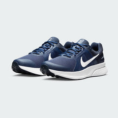 Angled view of two Nike Run Swift 2 Men's navy running shoes, side by side, showcasing their versatile design and cushioned profile.