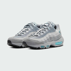 Angled view of two Nike Air Max 95 Men's running shoes in grey, blue, and black, side by side, showcasing their timeless design and layered upper.