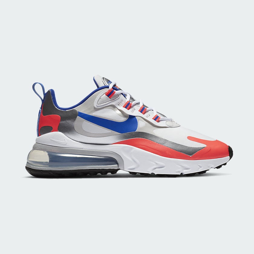 Nike Air Max 270 React Women's trainers in white with racer blue and flash crimson accents, side profile showing prominent 270-degree visible Max Air unit and React foam midsole