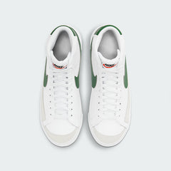 Top-down view of a pair of Nike Blazer Mid '77 Juniors' trainers in white, highlighting their structured silhouette and lace-up closure.