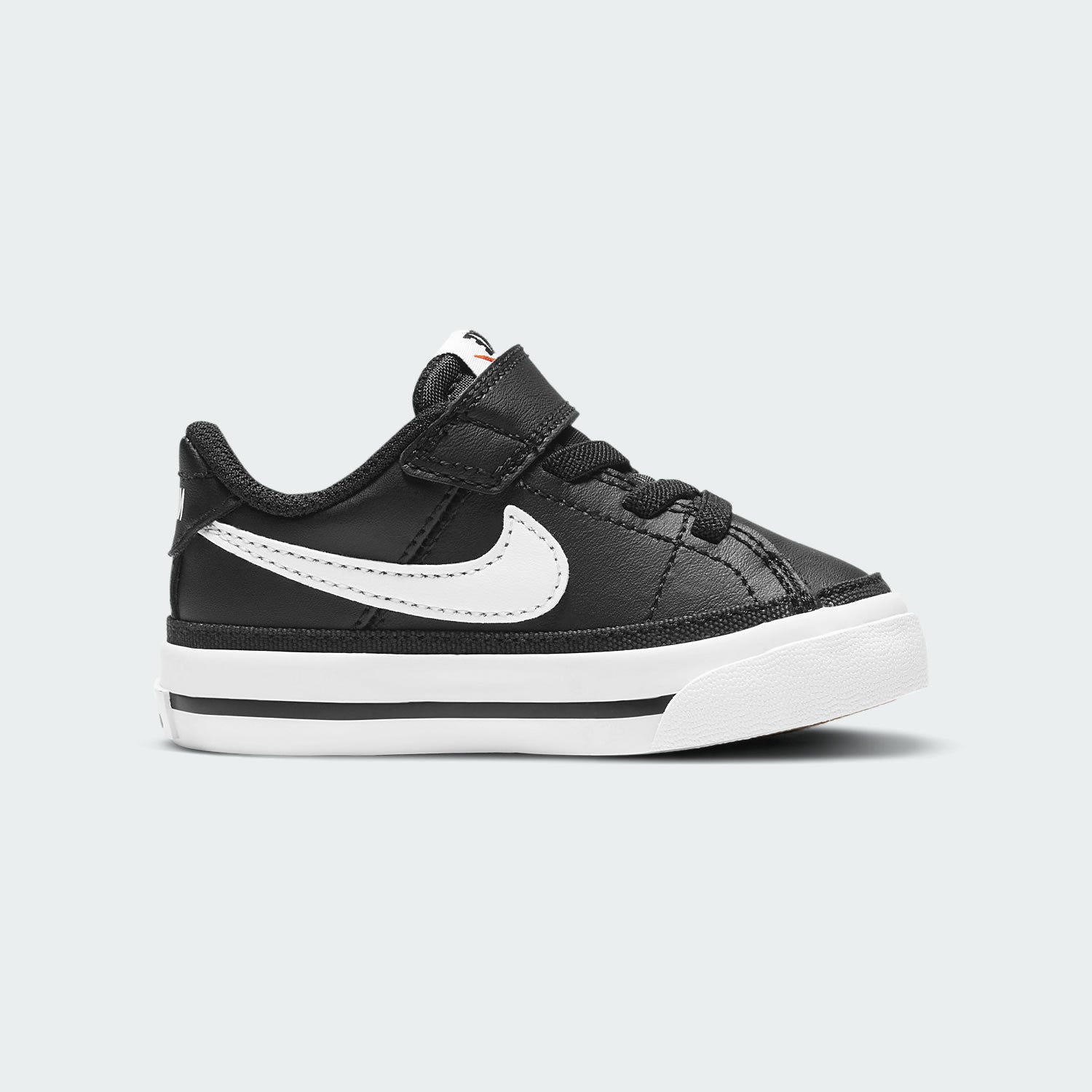 Nike Court Legacy Toddlers' shoes in black with white Nike Swoosh, side profile showing synthetic leather upper, hook-and-loop strap, and rubber sole.