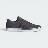 Highlights the high-velocity red accents and the professional depth of the grey synthetic nubuck.