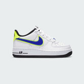 Nike Air Force 1 '07 Juniors' trainers in white with a racer blue Swoosh and volt accents, side profile showing classic leather upper and perforated toe box.