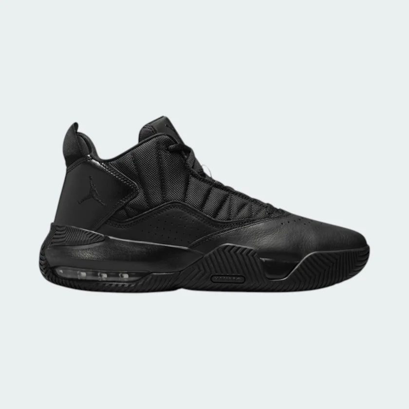 Jordan Stay Loyal men's trainers in black and cool grey, side profile showing layered leather and textile upper, and subtle Air Jordan design elements.